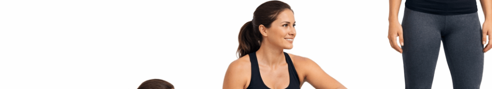 Woman in black tank top and gray leggings moving from lying on stomach to seated to standing position